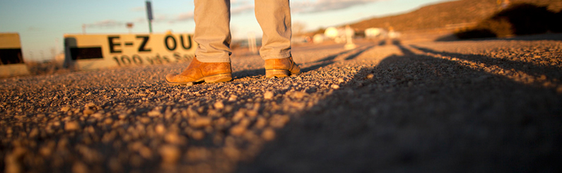 Cowboy boots on gravel road image